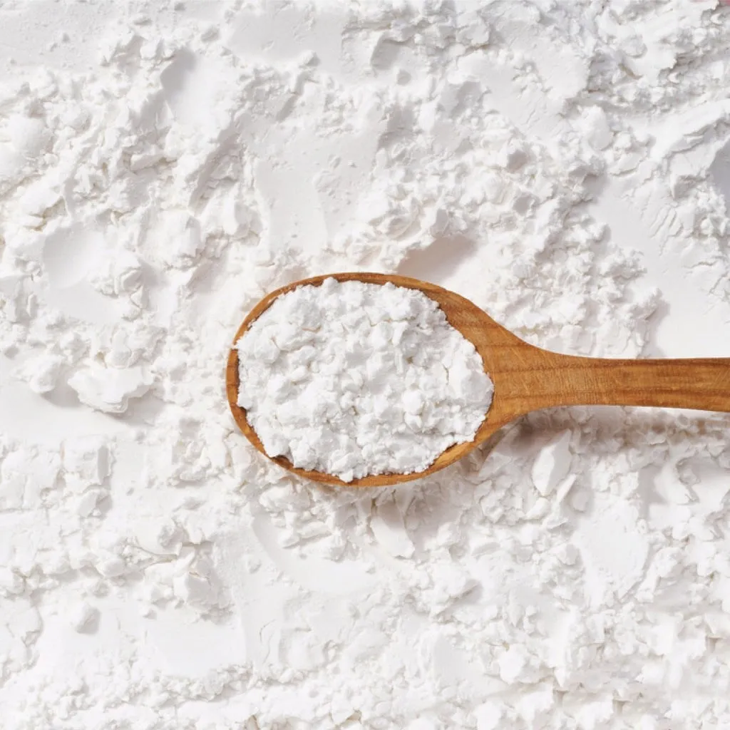 A wooden scoop of white powder